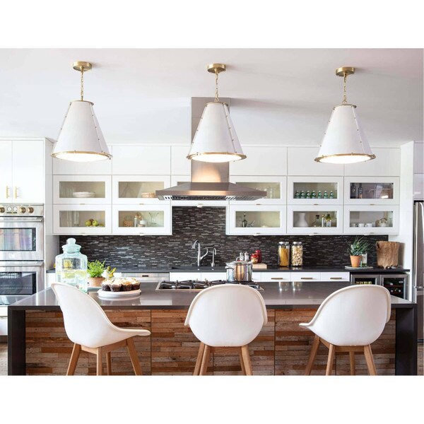 Kitchen with French chandeliers, a stone kitchen island, and white chairs